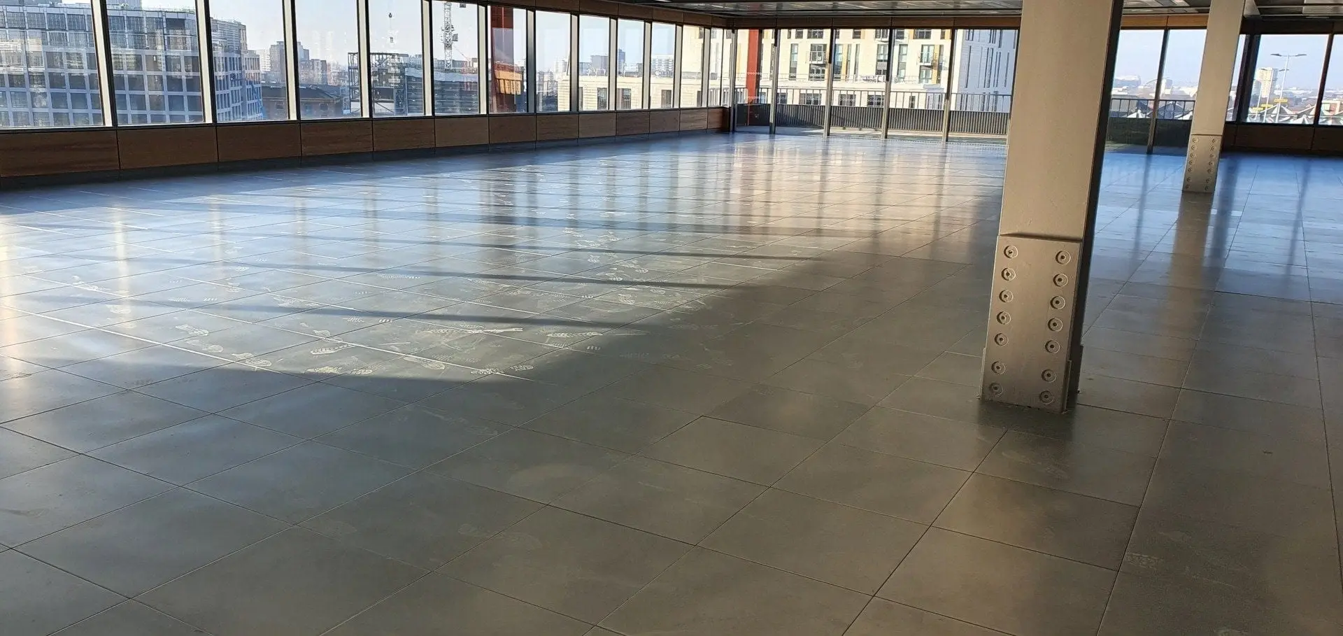 Open plan office with raised access floor and city views BJM Flooring