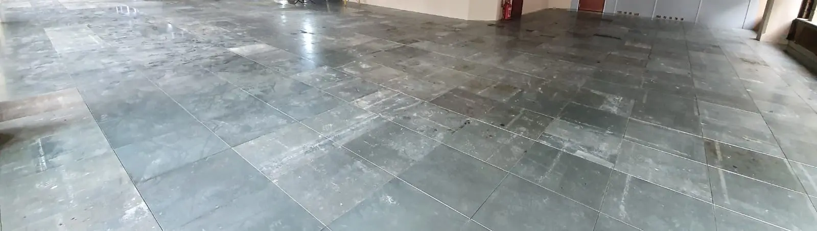 Reclaimed raised access floor panels laid across a commercial space BJM Flooring